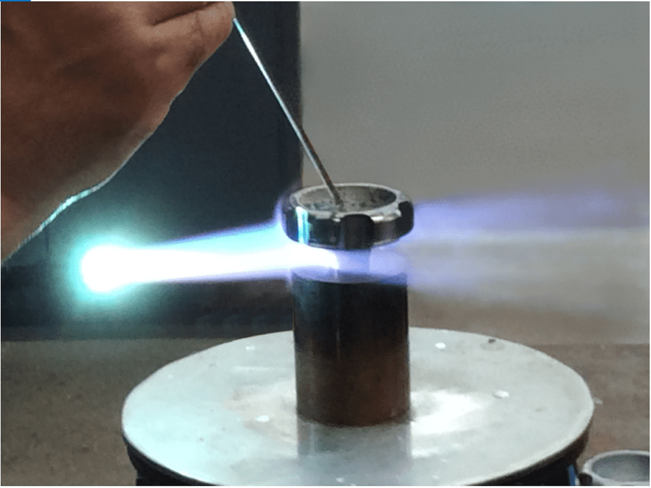 A circular piece of metal being brazed